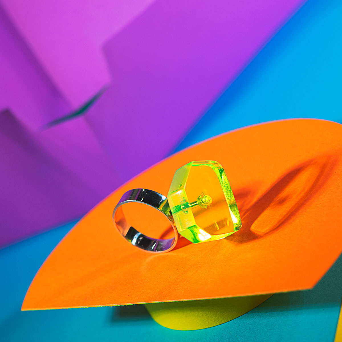 Neon green acrylic polygon ring with silver band. A take on a modern diamond ring